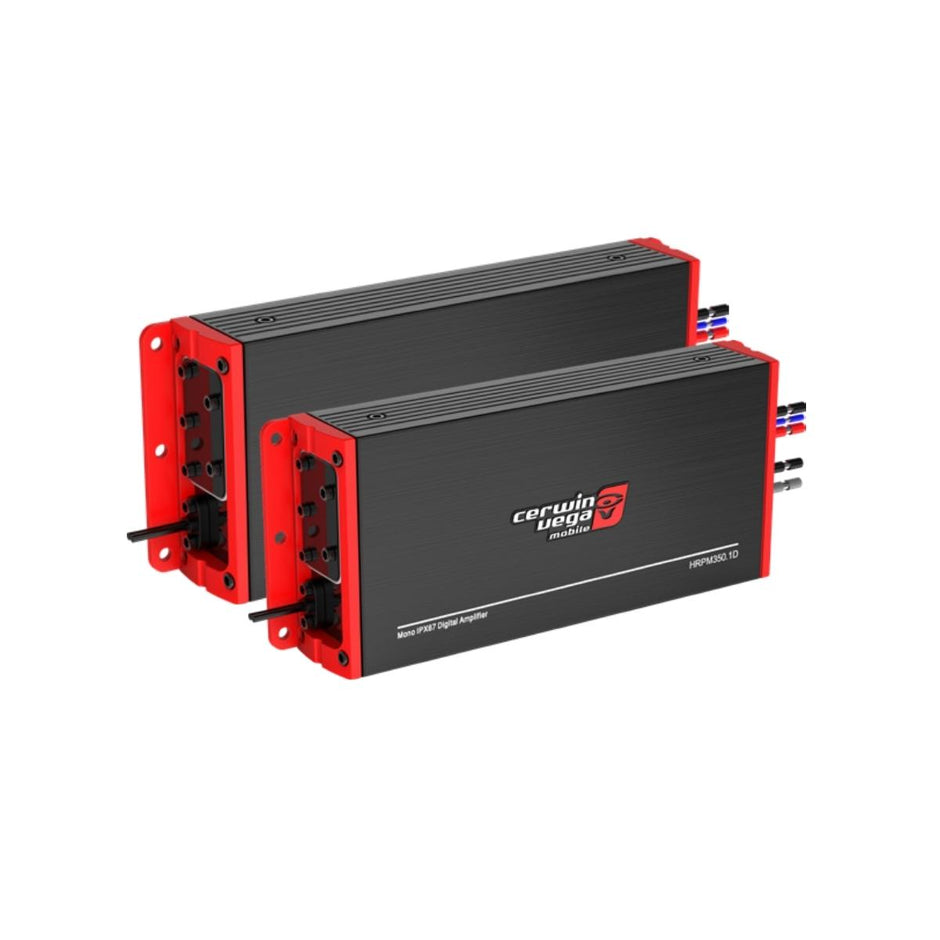 Two RPMX3KM3 waterproof amplifiers, part of the 2017+ Can Am Maverick X3/X3 Max Speaker Kit, are seen with black housing and red side panels. They feature various input/output connectors on the side with the Cerwin-Vega logo and model number H70400.4D visible on top, positioned parallel to each other.