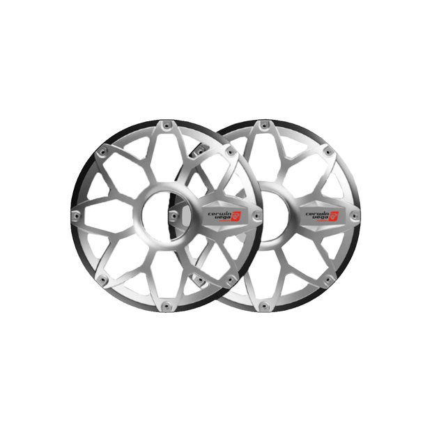 The image shows two RPM Stroker 10" Flush Mount Speaker Grills in brushed aluminum and black, each with a spoke-like design and central hubcap similar to automotive wheel covers. They feature geometric patterns with a logo and red shield emblem in the inner section.