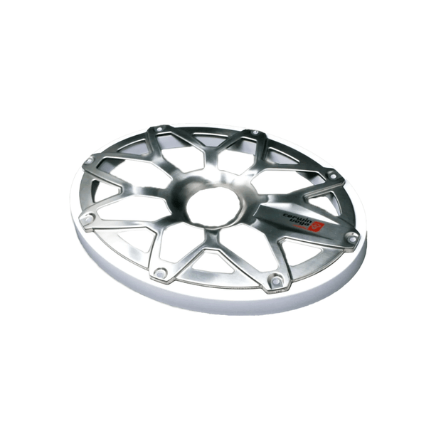 A metallic, circular car rim with a geometric, multi-spoke pattern gleams in silver, featuring the RPM STROKER logo on one spoke. It shines beside an RPM Stroker 6”X9” Flush Mount Speaker Grill against a white background.