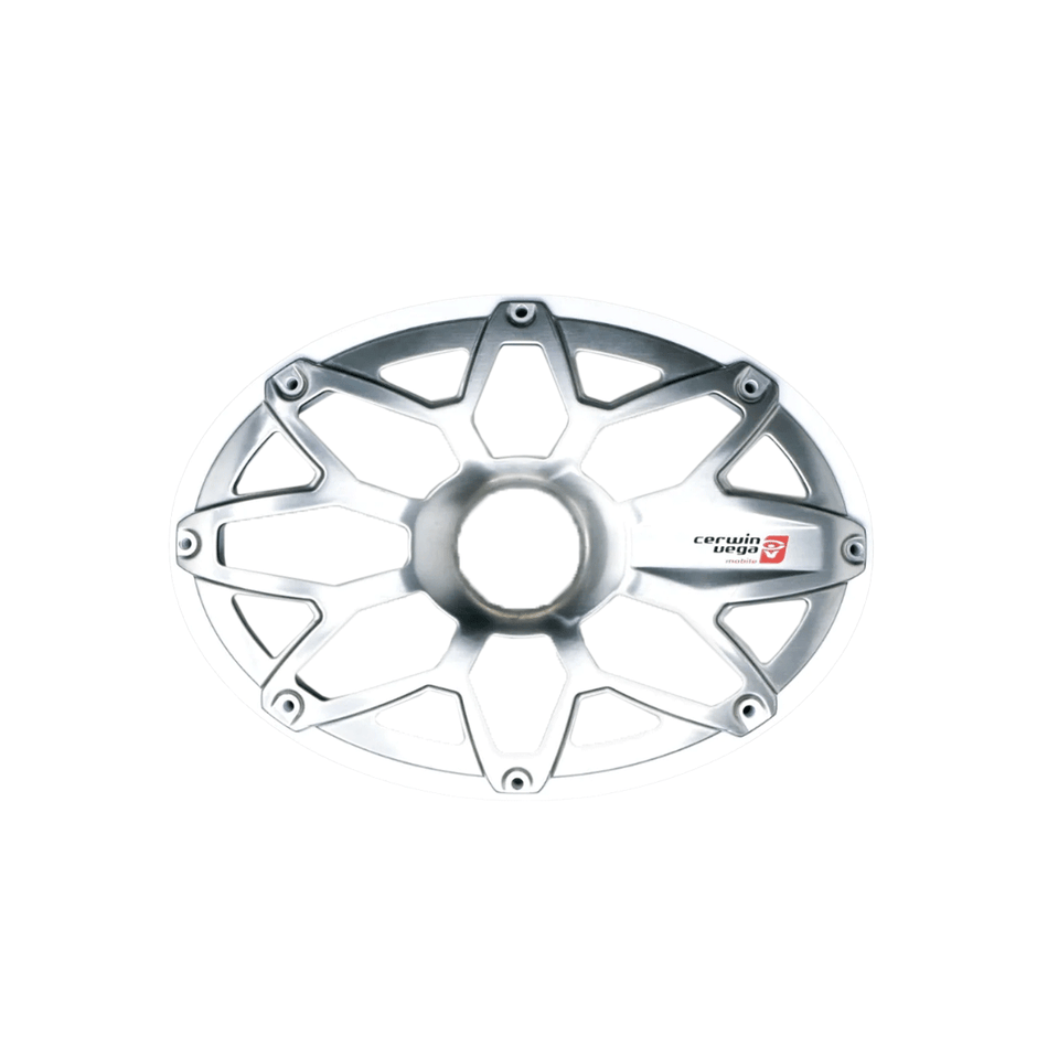 The RPM Stroker 6”X9” Flush Mount Speaker Grill is a silver, oval hub cover with a geometric web design, featuring a central opening and interconnected spokes. It displays a red and white logo on one spoke, with its glossy surface elegantly reflecting light.