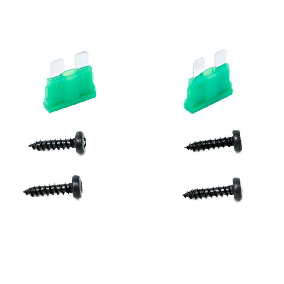 Two green blade fuses and four black screws are precisely arranged on a white background. The fuses sit side by side at the top, with the screws in two vertical rows below, ready to power Cerwin Vega's CVP Series 4-Channel Full Range Class AB Amplifier - CVP1600.4D for extreme bass.