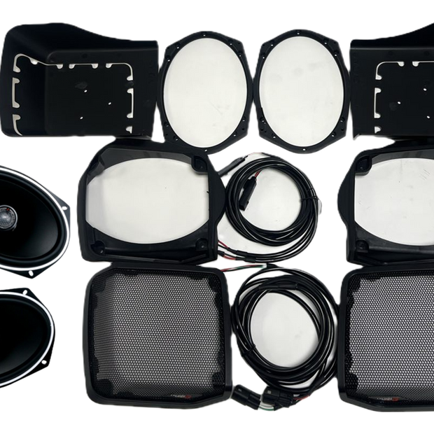 The 98-2013 Harley Davidson Cut-in Lid Kit with ST69CX (4Ω) is meticulously arranged on a white background, featuring oval speakers, protective casings, round filters, and lengthy coiled cables for an exceptional audio clarity experience and enhanced audio upgrade.