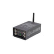 The image showcases the DANI | SKAA PRO™ TRANSMITTER - PL5580, a sleek black wireless audio device offering low-latency transmission. It features four metal jacks, two control knobs, a small antenna on top, and has 