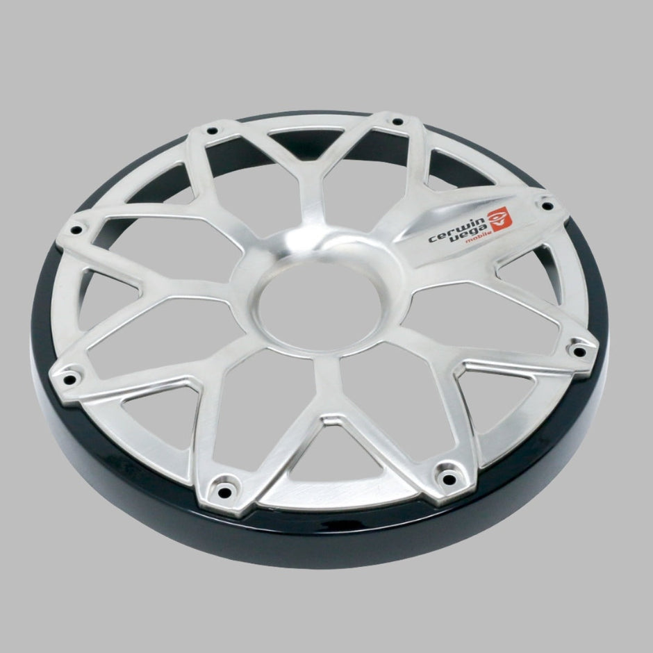 The image shows a silver metallic wheel cover with a design resembling the RPM Stroker 6.5” Flush Mount Speaker Grill. It features spoke-like eight-point extensions forming a star pattern, a shiny black rim edge, and the red and white 