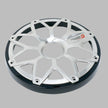 The image shows a silver metallic wheel cover with a design resembling the RPM Stroker 6.5” Flush Mount Speaker Grill. It features spoke-like eight-point extensions forming a star pattern, a shiny black rim edge, and the red and white 