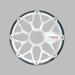 A silver and black star-shaped car wheel rim, resembling the RPM Stroker 8” Flush Mount Speaker Grill with its eight spokes and triangular cutouts, is displayed on a gray background. The glossy rim features the 