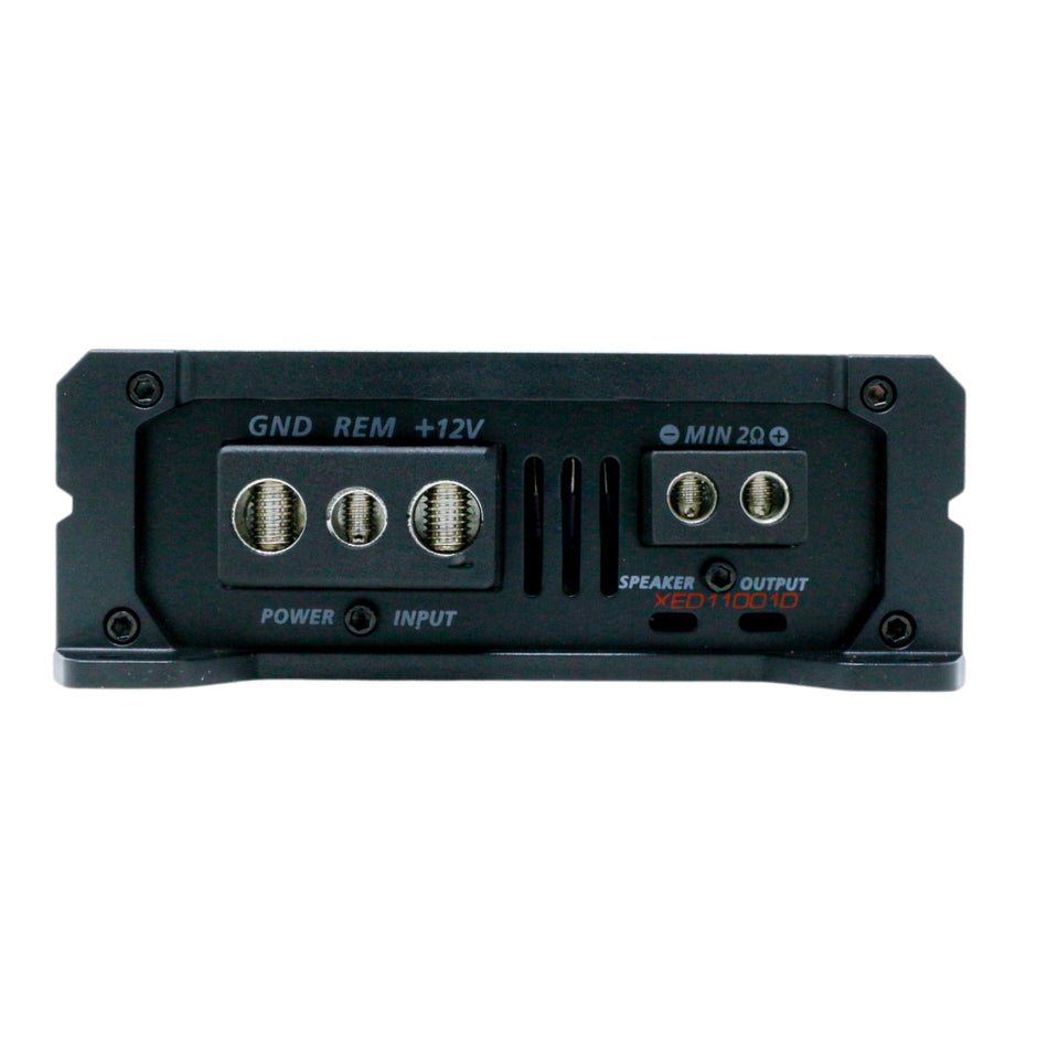 Close-up of a black terminal panel for the XED Series 1-Channel Mono Block Class-D Amplifier - XED11001D, showing labeled GND, REM, and +12V connections. It features input/output screws and a 